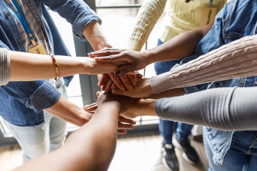 hands in circle celebrating