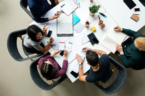 coworkers looking at documents overhead shot