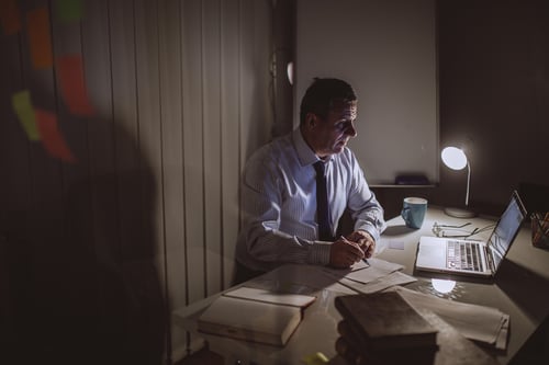 mature professional working late at night on computer