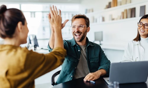 two people high fiving in celebration