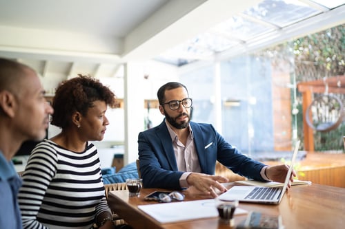 serious advisor conversation with clients while looking at a computer