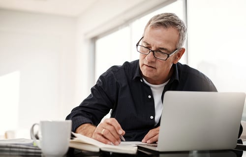 man looking at financial documents