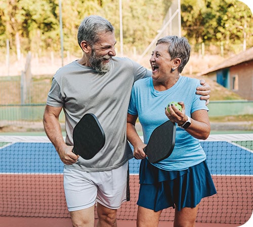 wm-site-wealth-management-mature-couple-playing-pickleball-right