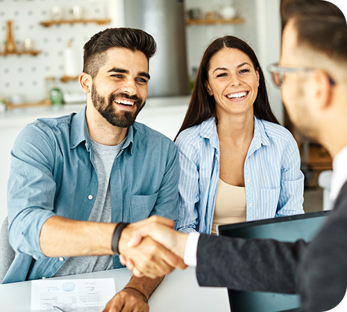young-couple-shakinghands-with-financial-advisor-right